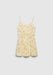 A cream-colored slip dress with thin spaghetti straps and a soft flared silhouette, featuring a delicate yellow floral print, displayed against a plain background.