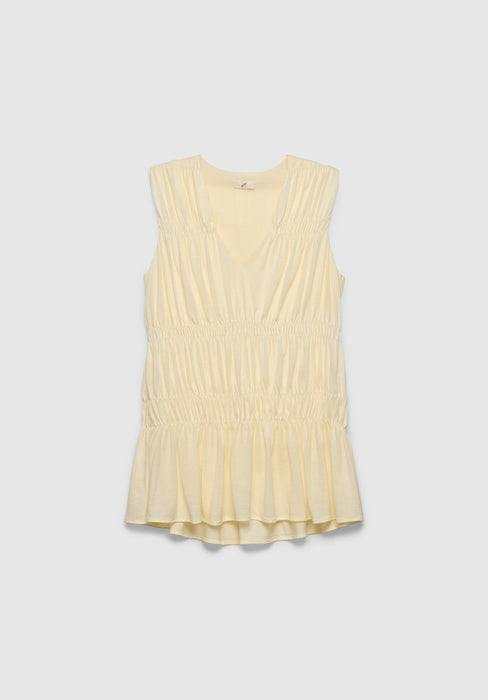 A light cream sleeveless top with a V-neckline, featuring gathered detailing at the shoulders and waist and a softly flared hem, displayed against a plain background.