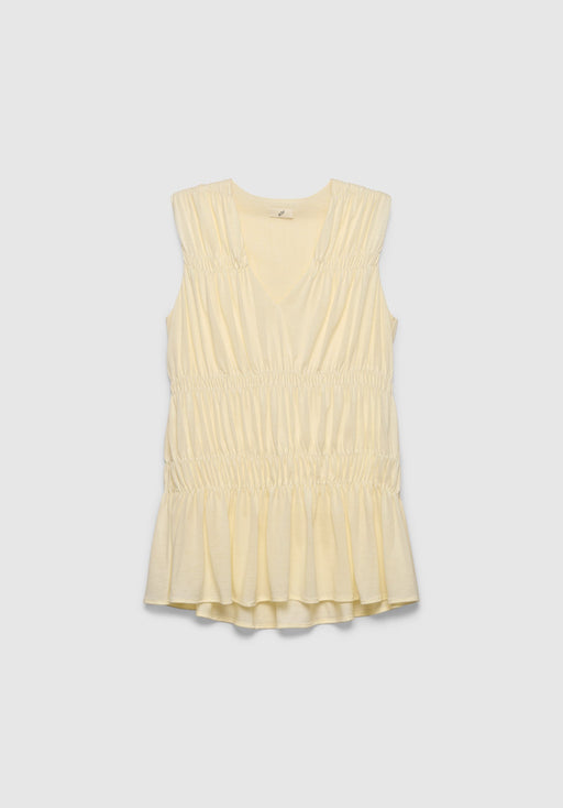 A light cream sleeveless top with a V-neckline, featuring gathered detailing at the shoulders and waist and a softly flared hem, displayed against a plain background.