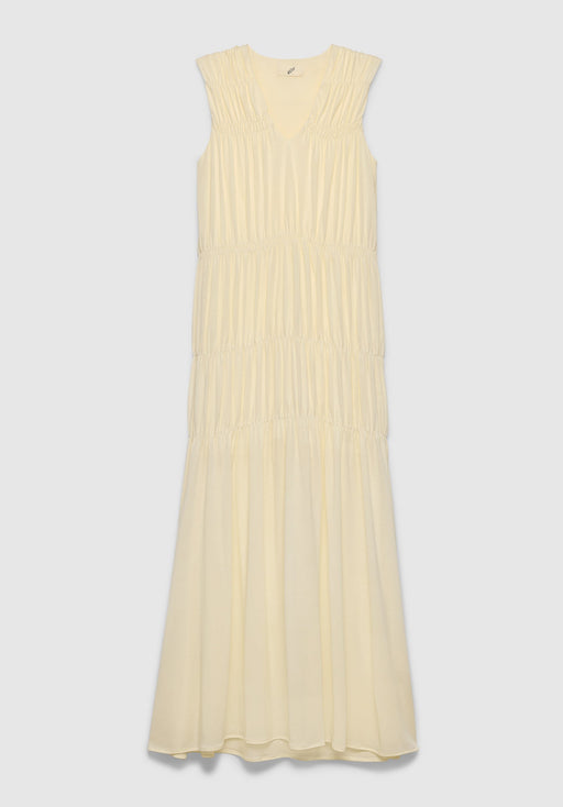 A light cream sleeveless maxi dress with a V-neckline and a tiered, gathered design, featuring soft pleating and a flowing silhouette, displayed against a plain background.