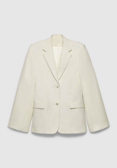 A cream-colored tailored blazer with a structured fit, featuring a notched lapel, two-button front closure, and flap pockets, displayed against a plain background.