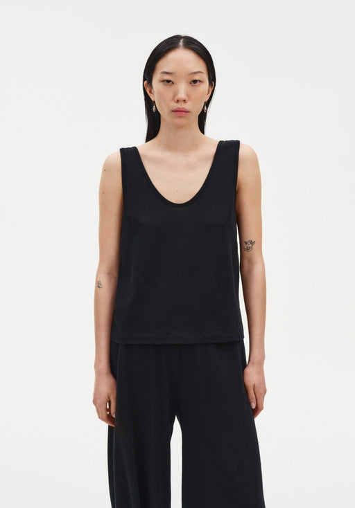 Black sleeveless tank top with a relaxed fit, featuring a scoop neckline and clean, minimal silhouette.