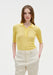 Front view of a model wearing a fitted yellow ribbed short-sleeve polo top with buttons, tucked into high-waisted cream trousers with hands in pockets.
