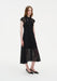 Three-quarter view of a woman wearing a black semi-sheer lace midi dress with a pointed collar, button-down front, and cap sleeves, featuring a fitted bodice and softly flared skirt with sheer lace hem.