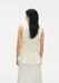 Back view of a light cream sleeveless top featuring soft, gathered tiers and a gently flared hem, highlighting its textured, flowy design against a plain background.